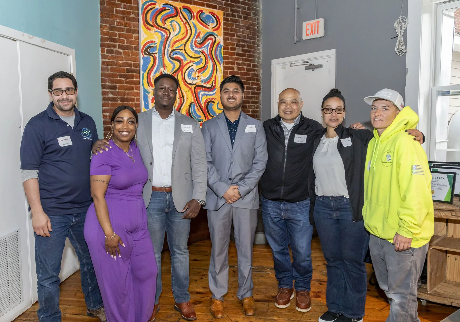 Members of the 2024 Emerald Cities Collaborative cohort standing together at an event.